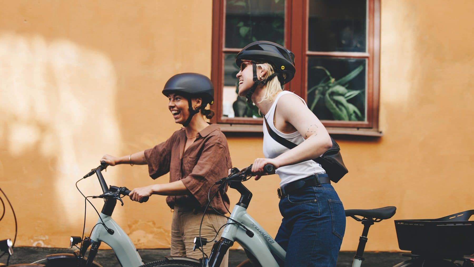 Zwei Fahrerinnen mit City e-Bikes in der Stadt